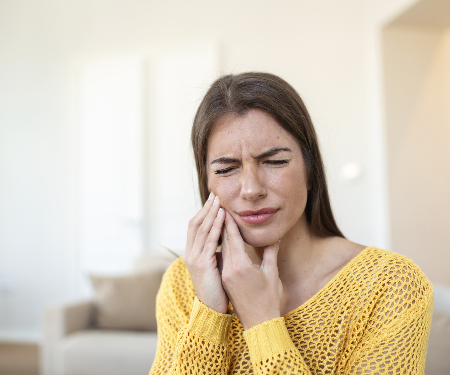 woman in pain due to tooth abscess