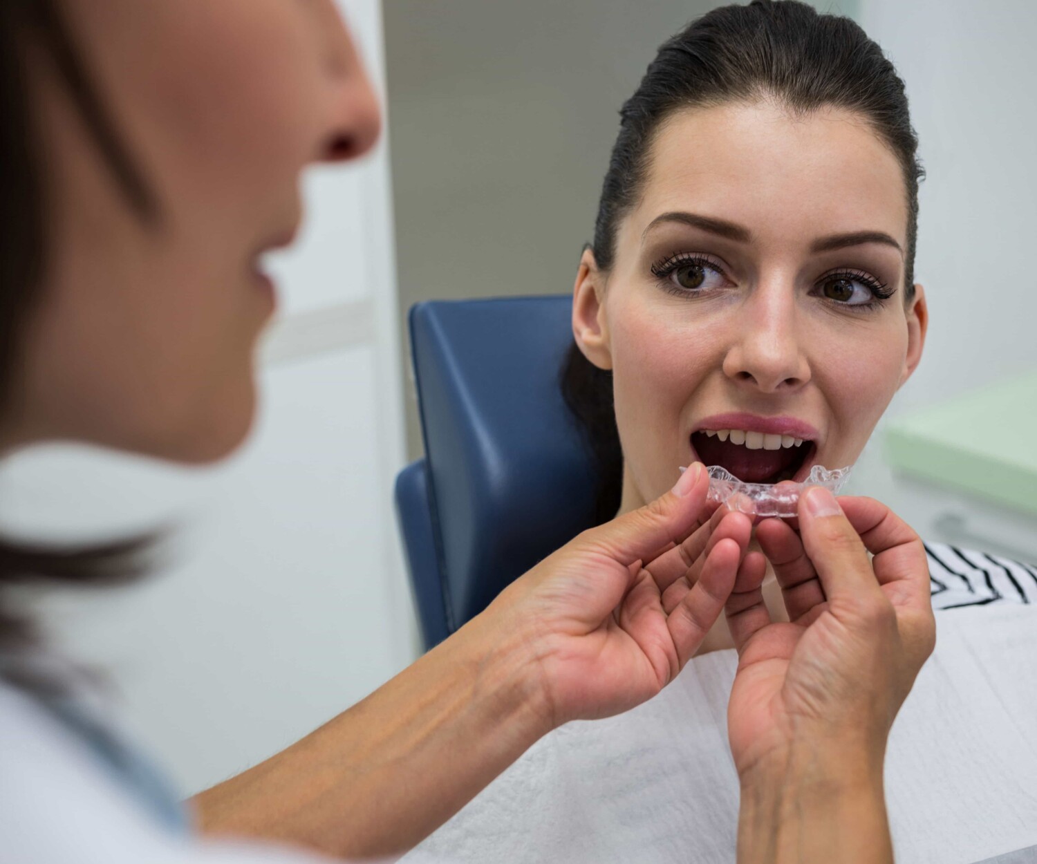 Patient putting on invisalign