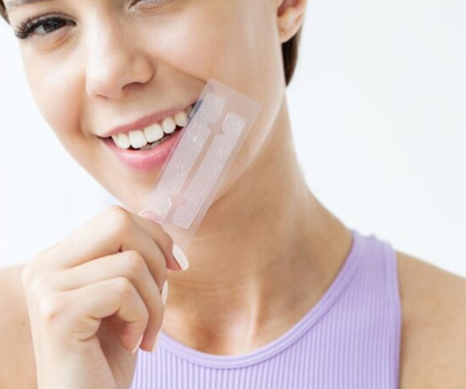Woman holding dental whitening strips