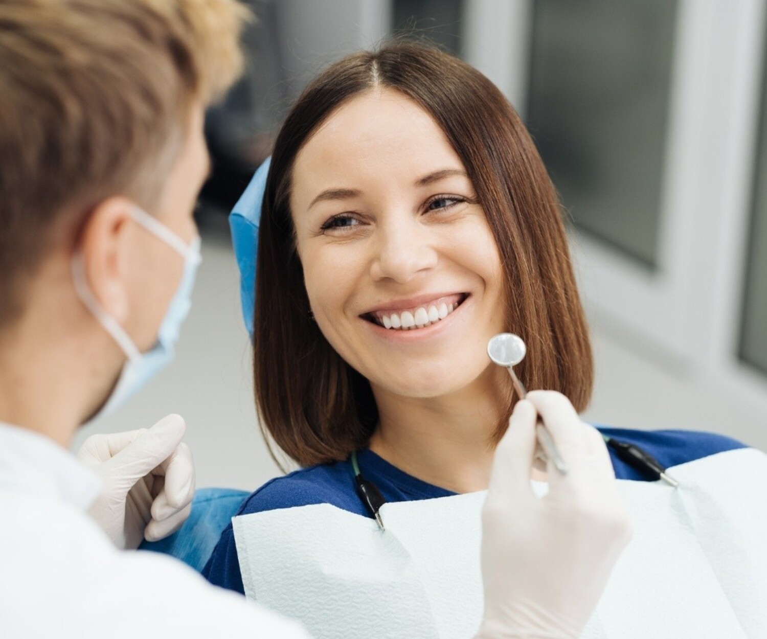Woman smiling during a cosmetic dental consultation about smile makeover treatment options